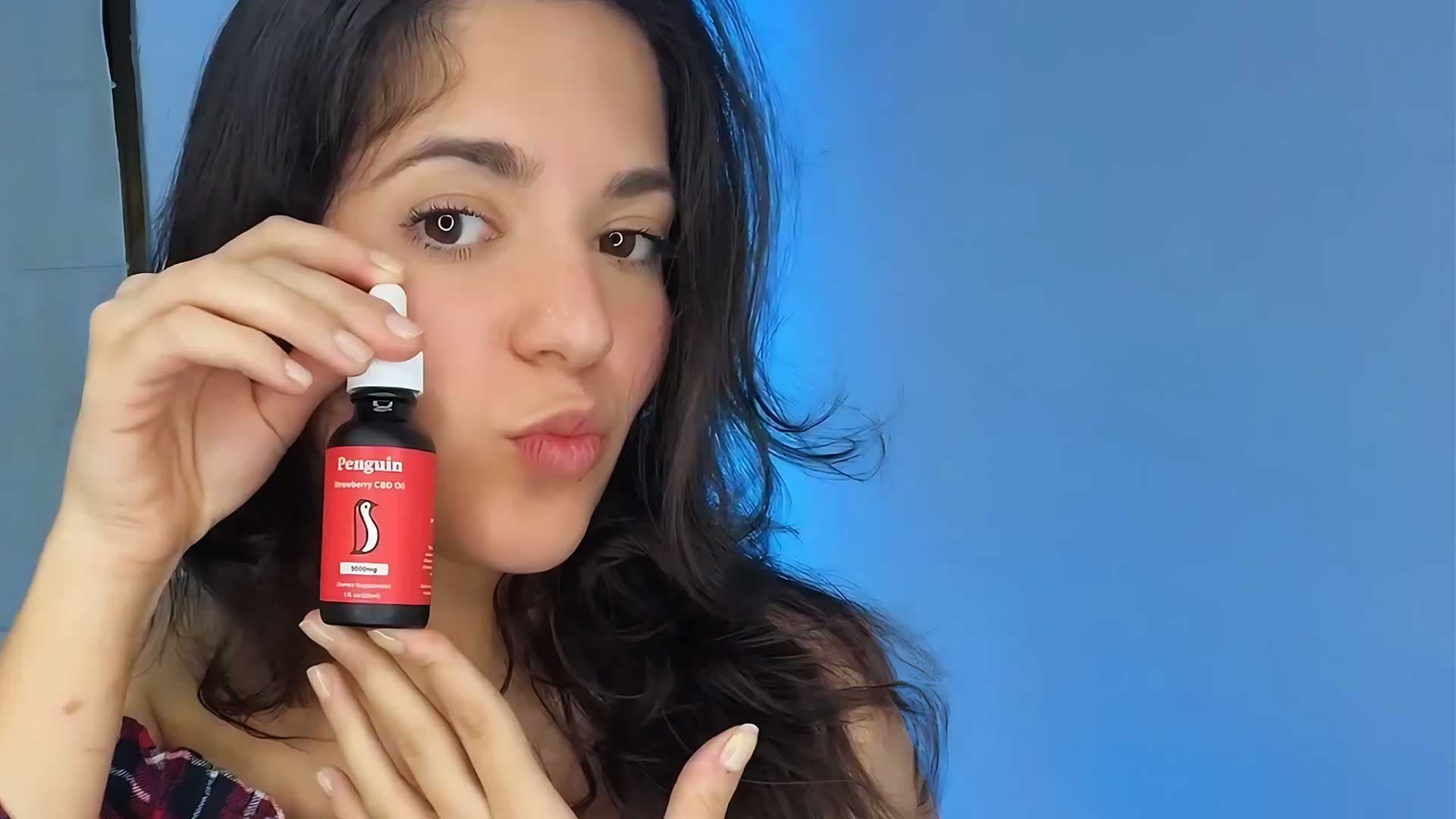 happy woman holding cbd oil